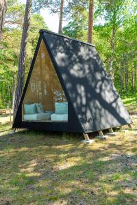 a black tent with a couch in a field at Forest View Cottage 