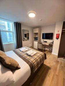 Ένα ή περισσότερα κρεβάτια σε δωμάτιο στο Dalkeith Phoenix Aparthotel Ltd