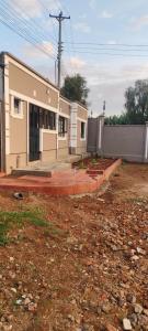 a building with a lot of windows in a yard at Mytlestayresidence in Kisii