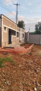 a house with a building in the middle of a yard at Mytlestayresidence in Kisii