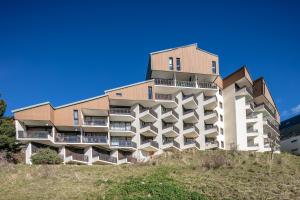 a building on top of a hill at Les Crocus - Magnifique Vue Montagne in Comboursière