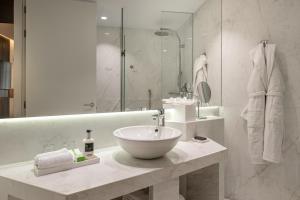 a bathroom with a bowl sink and a shower at Hyatt Centric Gran Via Madrid in Madrid
