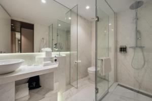 a bathroom with a shower and a sink and a toilet at Hyatt Centric Gran Via Madrid in Madrid
