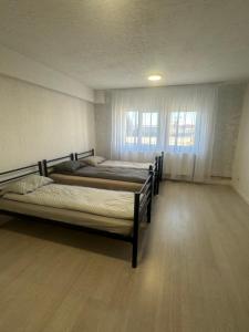 due letti in una stanza con finestra di Apartamente Viglo Boutique Complex a Baia Mare