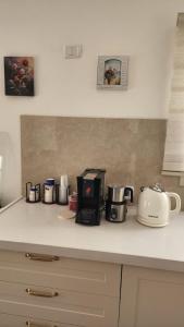 a kitchen counter with various appliances on a counter top at צימר החורש in Dāliyat el Karmil