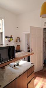 a kitchen with a counter with a microwave on it at Pousada Hostel Trilhas e Rotas - Av Paulista - Bela Vista in São Paulo