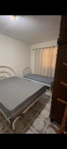 a bedroom with two beds and a window at Fazenda Torrão da Serra in Guarulhos