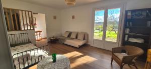 a living room with a bed and a couch at Maison de vacances au milieu des vignes in Cazaubon