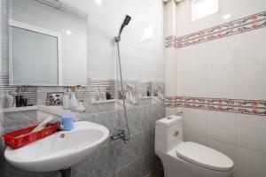 a bathroom with a white toilet and a sink at OYO 1187 Rose And Ross Place Budget Hotel And Private Resort in Kabaong +37 photos