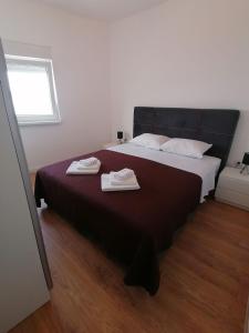 a bedroom with a bed with two towels on it at Galešnjak in Sveti Petar