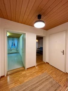 an empty living room with a wooden ceiling at Zurich Essentials Simple Apartment in Zürich