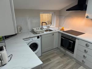 a kitchen with a washing machine and a sink at Modern 2BR Blairgowrie Cottage in Blairgowrie