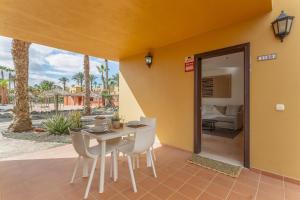 a dining room with a table and chairs on a patio at Casa Piña Colada in Corralejo