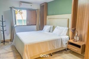 Ένα ή περισσότερα κρεβάτια σε δωμάτιο στο Casa Beira-Mar com Piscina em Jacumã by Qavi