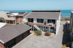 an aerial view of a house with the ocean in the background at Oceana - A Panoramic Beachfront Escape for Groups in Port Elliot