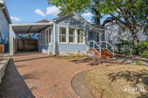a small blue house with a brick driveway at East Austin 2BR 1BA w Patio and Grill, Pet-Friendl Walk to 6th By Austin Vacay in Austin