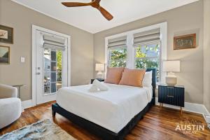 a bedroom with a large bed and two windows at East Austin 2BR 1BA w Patio and Grill, Pet-Friendl Walk to 6th By Austin Vacay in Austin +43 photos