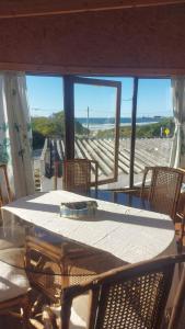 a table and chairs on a balcony with a view of the ocean at Herminia Sol in La Aguada