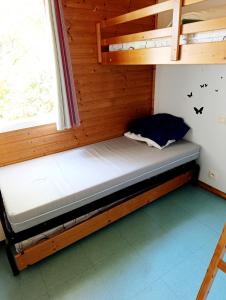 a bunk bed in a room with a window at Chalet 1 in Cazilhac +19 photos