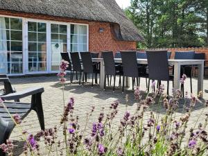 a group of chairs and a table in front of a building at Luxury Retreat near Beach - By Traum Ferienwohnungen in Husby