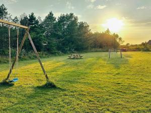 an open field with a picnic table and a swing at Luxury Retreat near Beach - By Traum Ferienwohnungen in Husby
