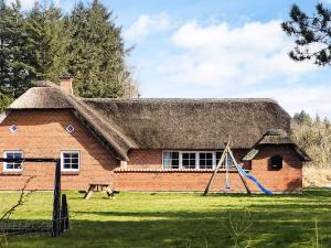 a brick house with a playground in front of it at Luxury Retreat near Beach - By Traum Ferienwohnungen in Husby
