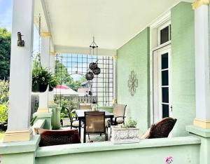 an outdoor patio with a table and chairs at Magnolia Suite- The Belvedere Inn in Oswego