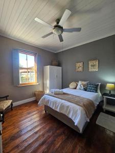 a bedroom with a bed and a ceiling fan at The Homestead at Koringberg Country Cottages in Koringberg