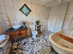 a bathroom with a sink and a toilet and a tub at The Homestead at Koringberg Country Cottages in Koringberg +19 photos