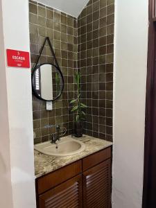 a bathroom with a sink and a mirror at Studios Casamarela in Mossoró +37 photos