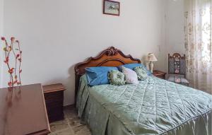 a bedroom with a bed with blue pillows at Lovely Home In Caranzavarese Ligure in Groppo