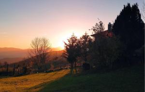 a sunset on a hill with trees in a field at Lovely Home In Caranzavarese Ligure in Groppo