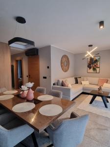 a living room with a table and a couch at Kasztanowy Zakątek in Szczyrk