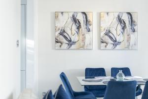 a dining room with a table and blue chairs at Casa Fresa - 224 King St in Broughty Ferry