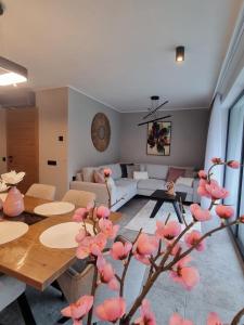 a living room with a table and a couch at Kasztanowy Zakątek in Szczyrk