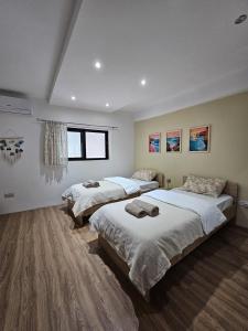 a bedroom with two beds and a window at Soulnest Peace bedroom in shared flat in Qbajjar