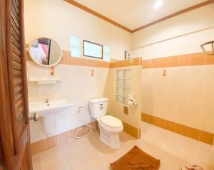 a bathroom with a toilet and a sink and a mirror at Na Soi 5 Chiangkhan in Chiang Khan +19 photos