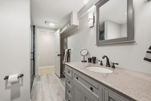 a bathroom with a sink and a mirror at 350 School House Road Eastham - Beach Dreams in Eastham +37 photos
