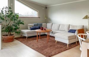 a living room with a couch and a table at 5 Bedroom Cozy Home In Onsala in Draget