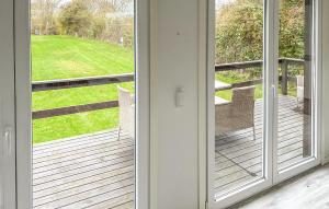 a sliding glass door with a view of a yard at 2 Bedroom Amazing Home In Samsø in Kolby Kås