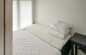 a white bed with two pillows on top of it at 2 Bedroom Amazing Home In Samsø in Kolby Kås