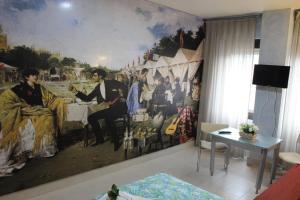 a room with a large painting on the wall at Triana Historic Center in Seville