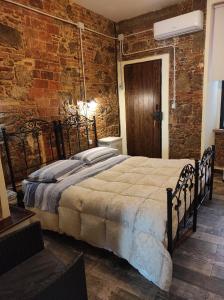 a bedroom with a large bed in a brick wall at Il Vico holiday home in Serra San Bruno