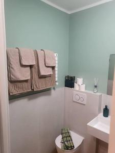 a bathroom with a toilet and a sink and towels at Elegante Suite in Centro Torino · Self Check-in in Turin