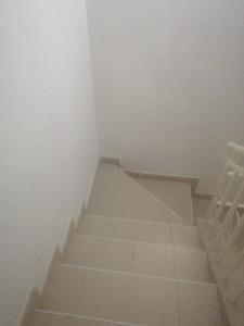 a staircase in a room with white walls at Mirema palace in Nairobi