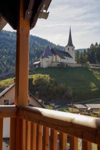 a view from a balcony of a church on a hill at MyAlpenloft 1 in Deutschgriffen