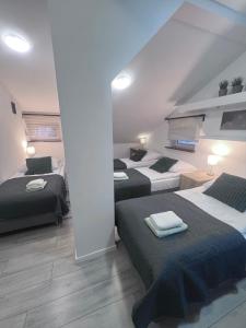 a bedroom with three beds in a room at Pokoje i Apartamenty Willa Bielany in Warsaw