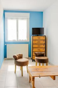 a living room with two chairs and a dresser at Proche Puy du Fou - Petite maison tendance loft in Saint-Laurent-sur-Sèvre