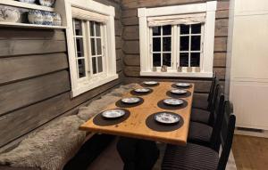 a wooden table in a room with chairs and a table sidx sidx sidx at 4 Bedroom Pet Friendly Home In Svingvoll in Aulstad