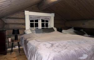 a bedroom with a large bed with a window at 4 Bedroom Pet Friendly Home In Svingvoll in Aulstad